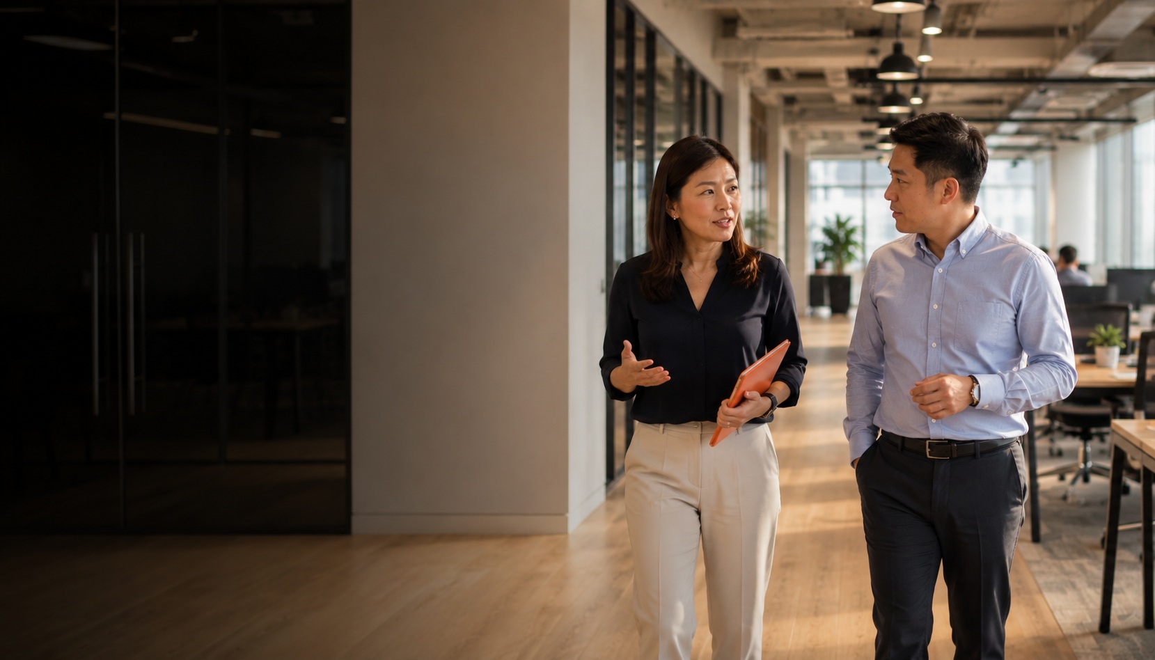 HR Shared Services Malaysia — People Profilers HR consultant walking with client through a Malaysia office, mid-conversation about HR services
